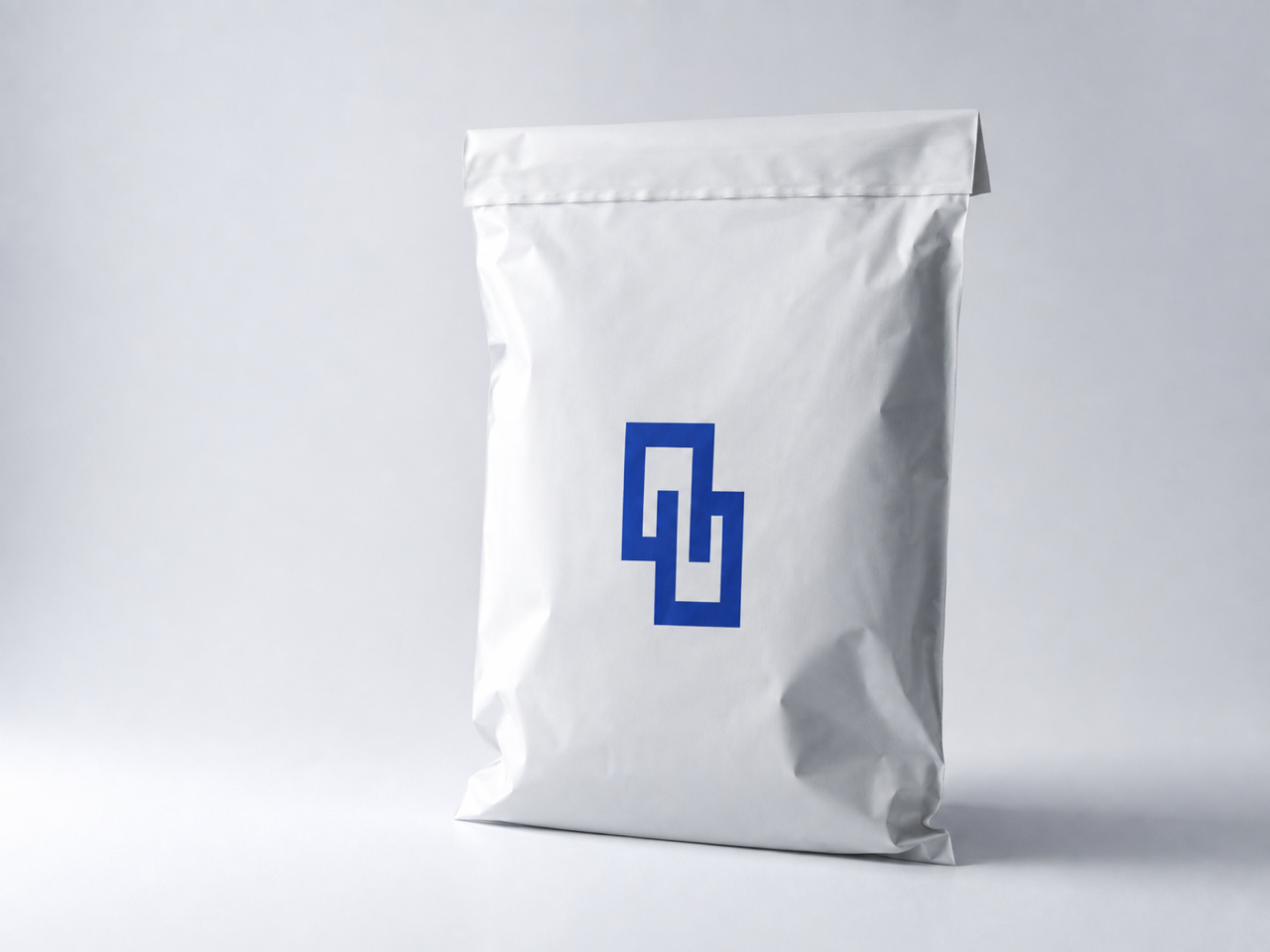 White flexible bio poly mailer with a cobalt geometric Easybox mark on a cool studio background