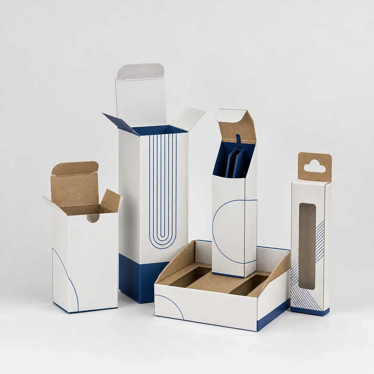 Cobalt and charcoal wellness cartons arranged with dropper bottles on a neutral studio set