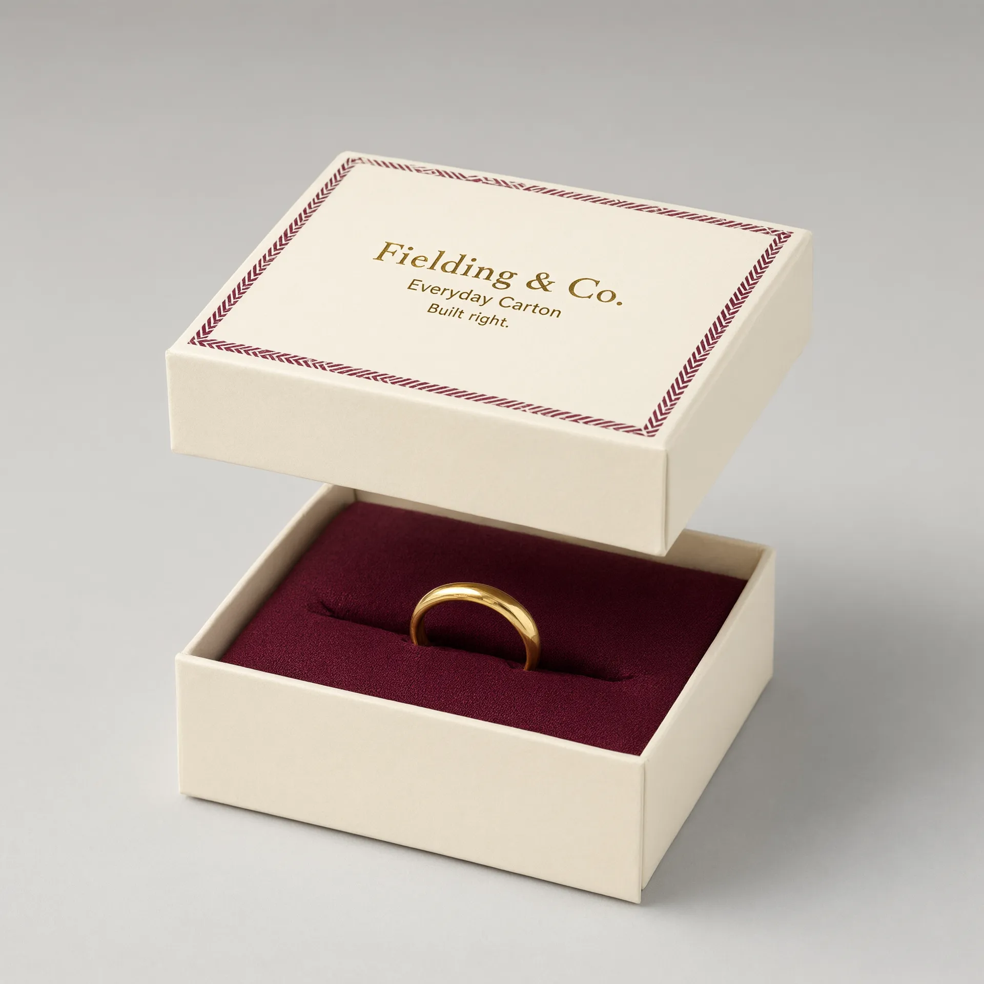 Ivory rigid jewelry box with lid lifted, showing a ring on a burgundy riser