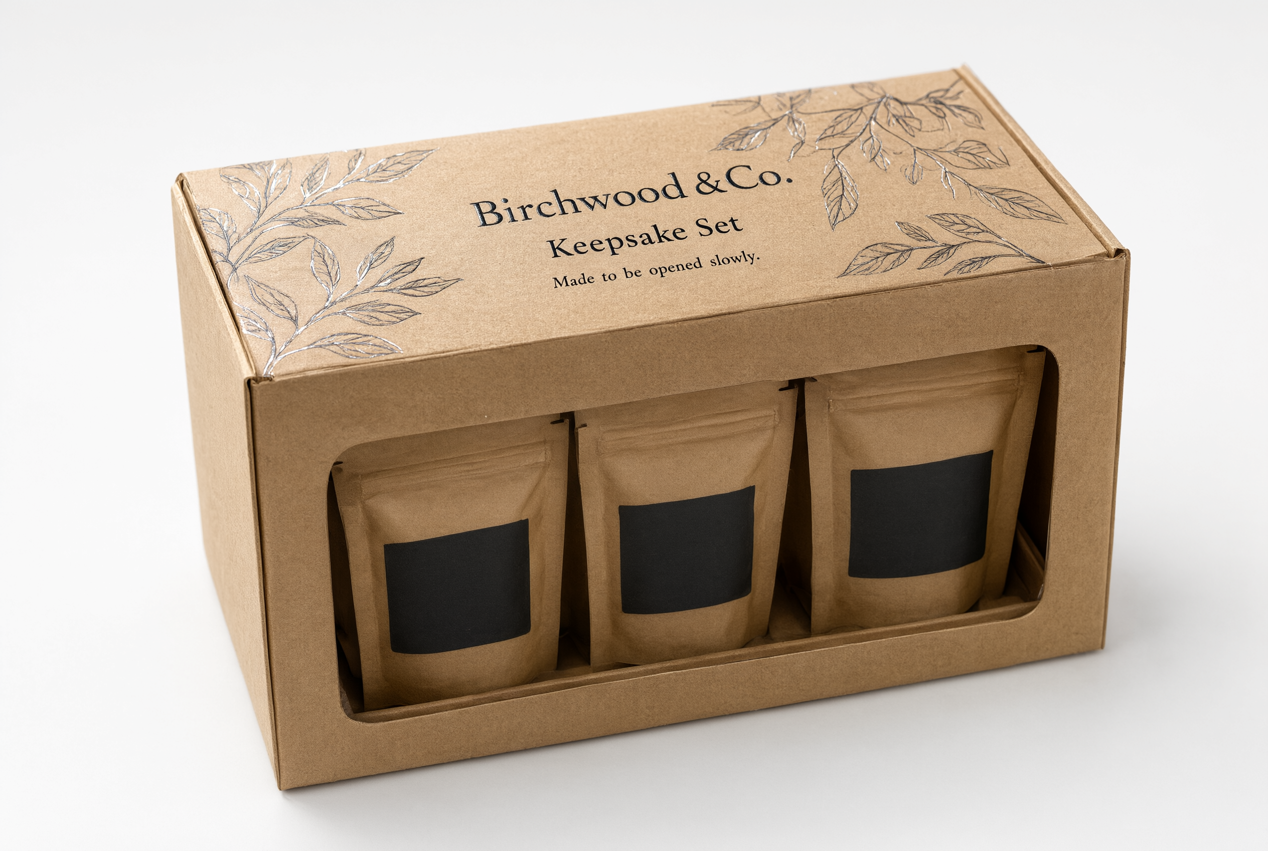 Kraft brown coffee gift carton styled on a neutral surface as a presented gift