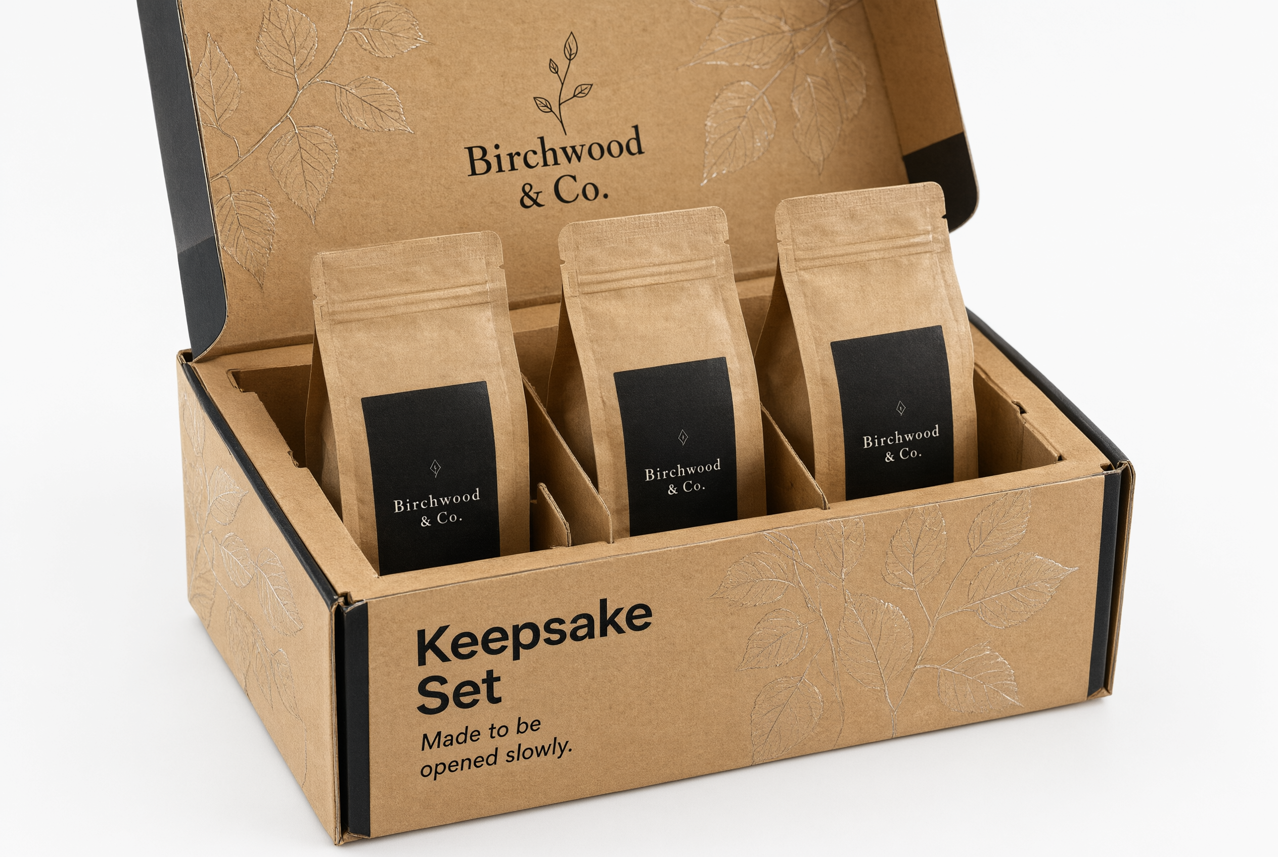 Open kraft folding carton showing a fitted tray holding three coffee pouches apart
