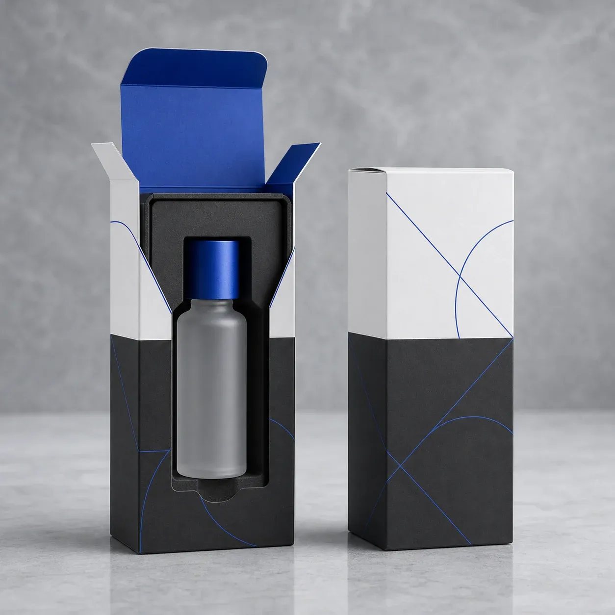 White and charcoal cosmetic bottle cartons with a fitted insert and cobalt details