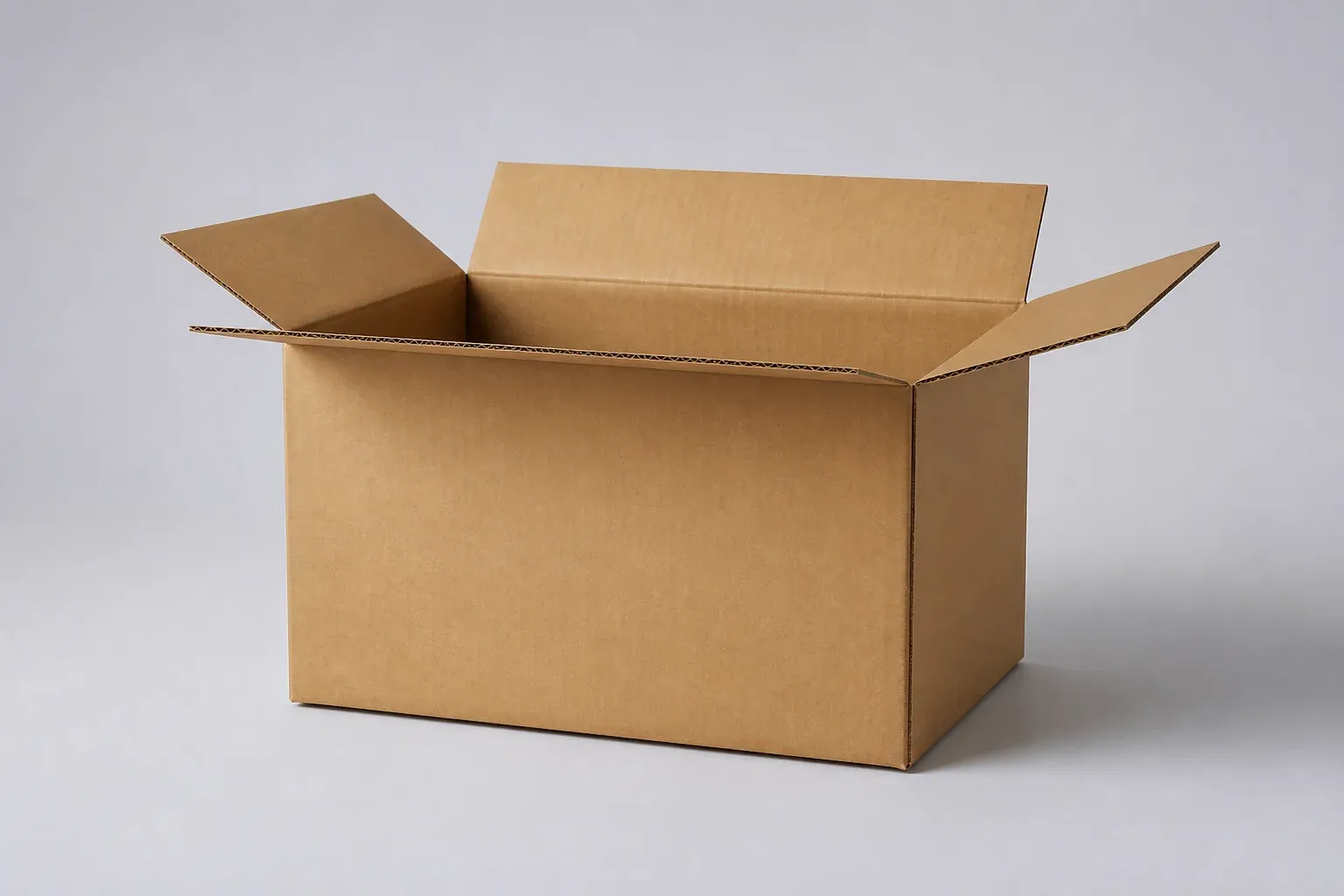 Open kraft corrugated e-commerce shipping carton on a gray studio background