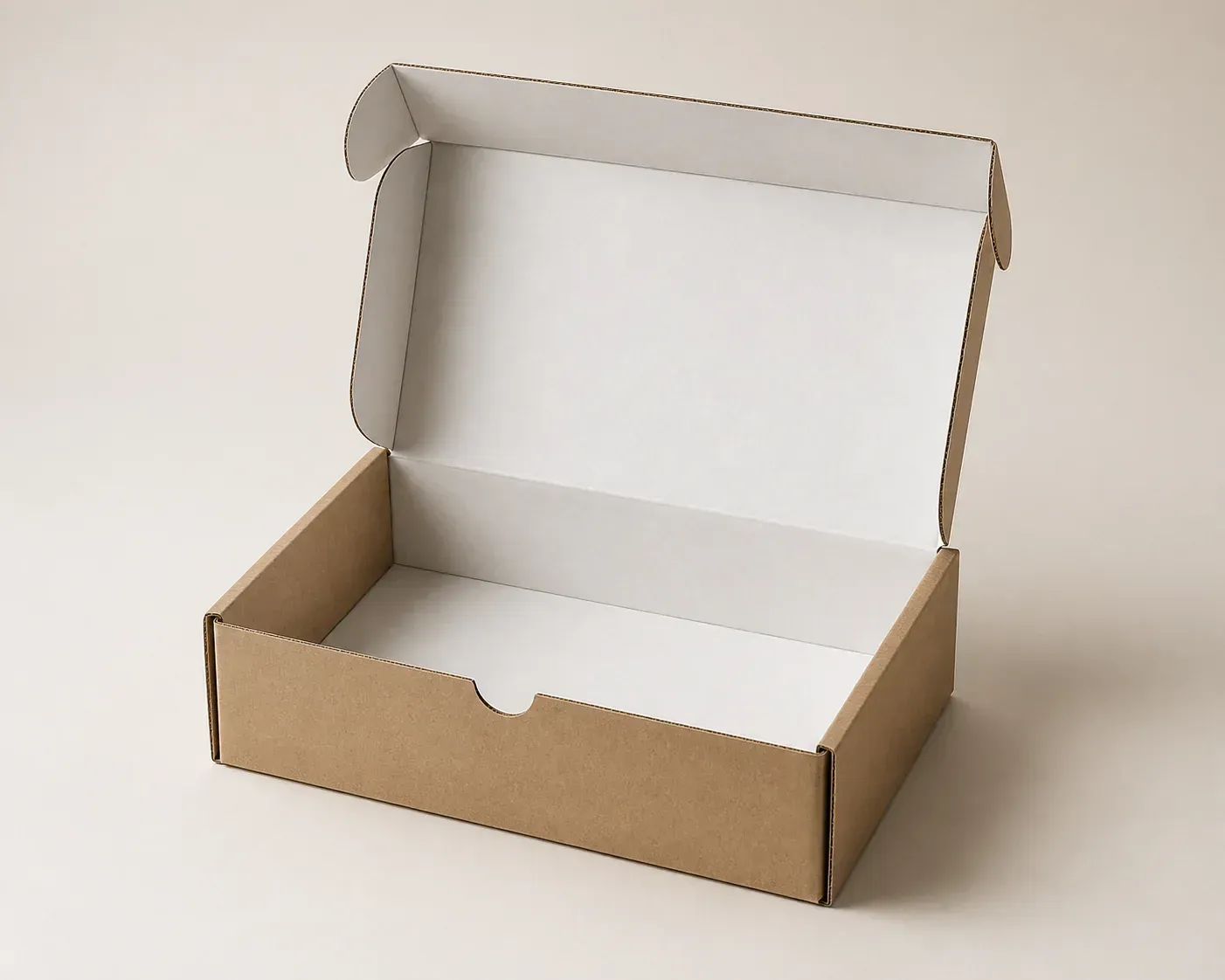 Open kraft corrugated mailer box with white interior in a studio setting