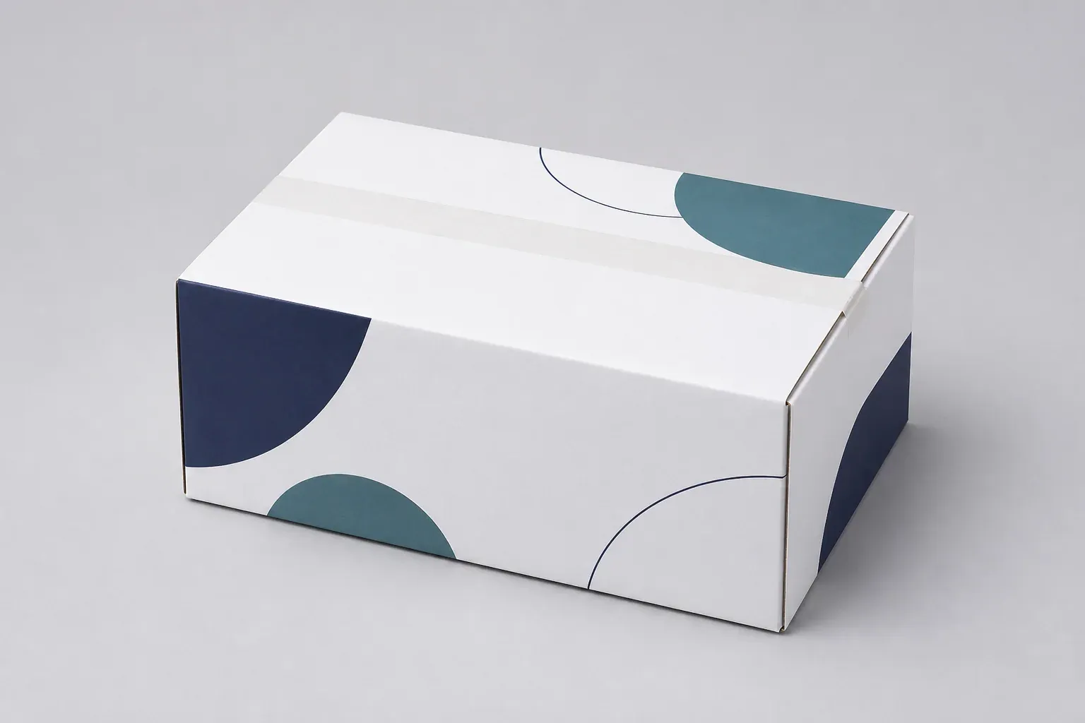 White corrugated shipping box with abstract navy and teal printed shapes