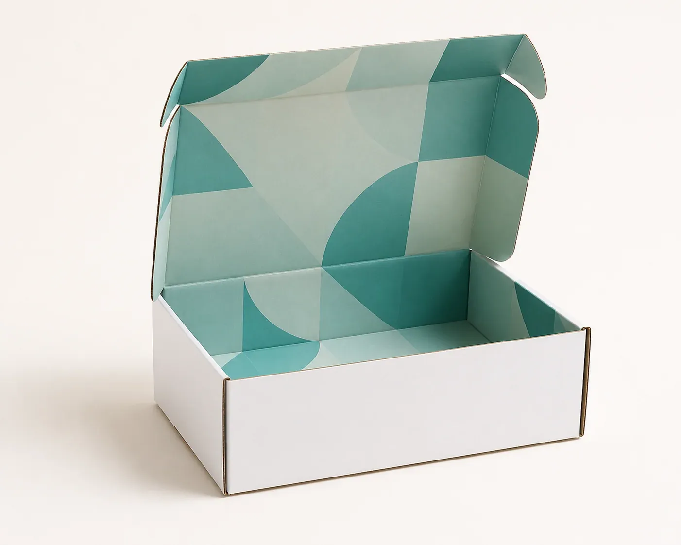 Open white corrugated mailer with abstract teal printing across interior panels