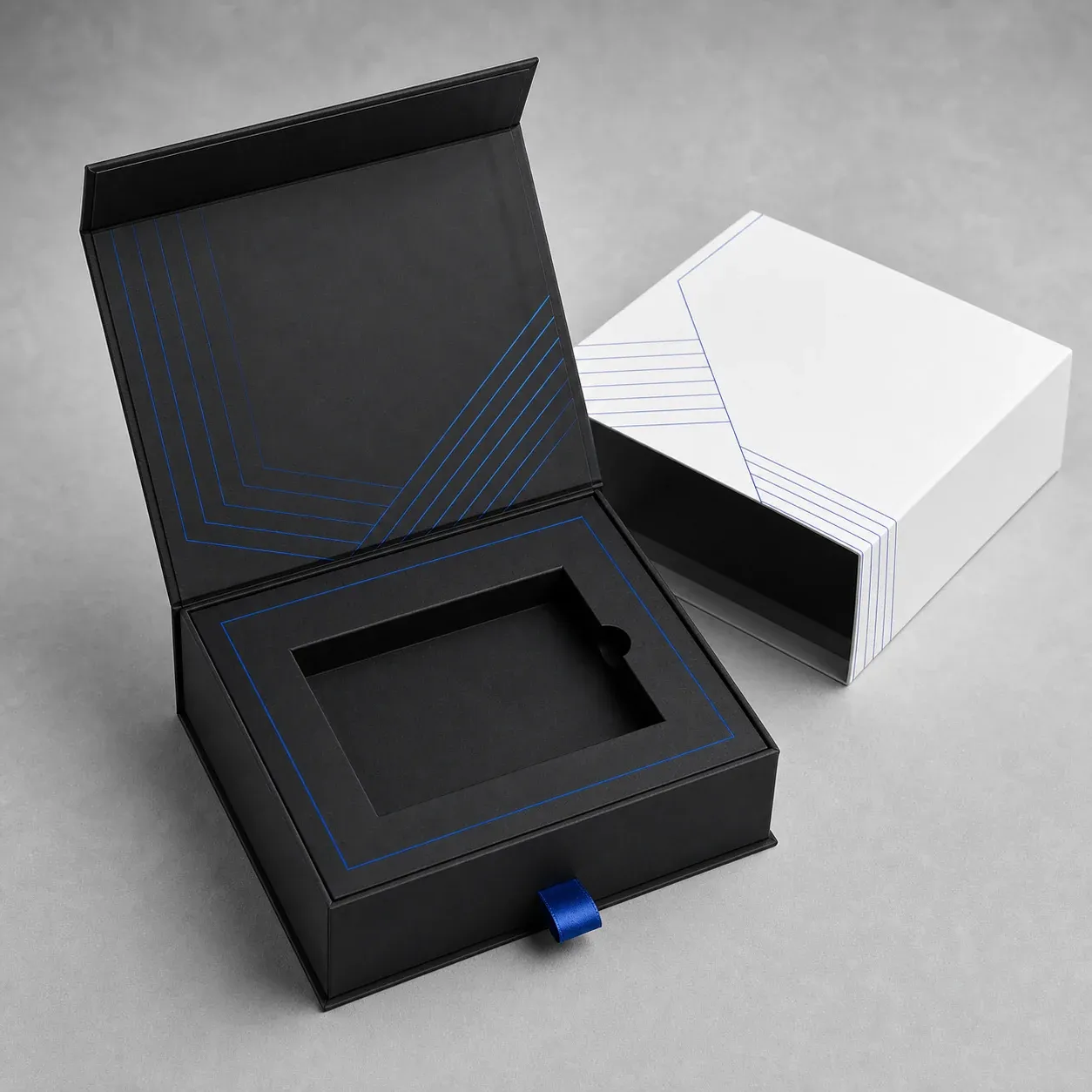 Open magnetic rigid gift box with a fitted insert and cobalt ribbon pull